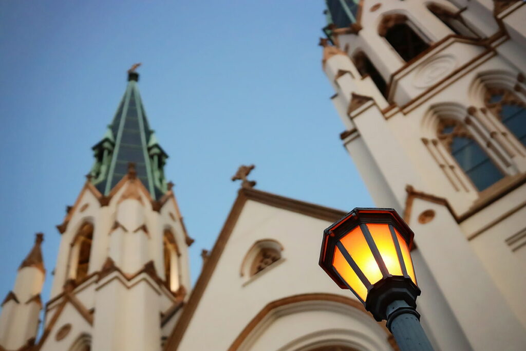 Creative angle of the facade of the Cathedral of St. John the Baptist with a dimly-lit lantern in the foreground