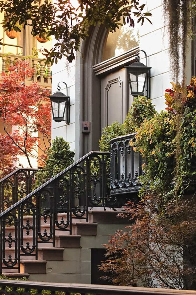 Front entrance to an elegant mansion surrounded by fall color in Savannah, Georgia