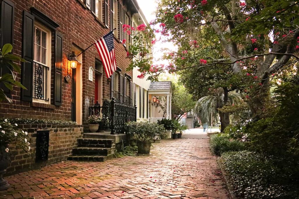 Historic homes with gas lanterns and a beautiful old brick sidewalk along Jones Street, one of the prettiest streets in Savannah GA