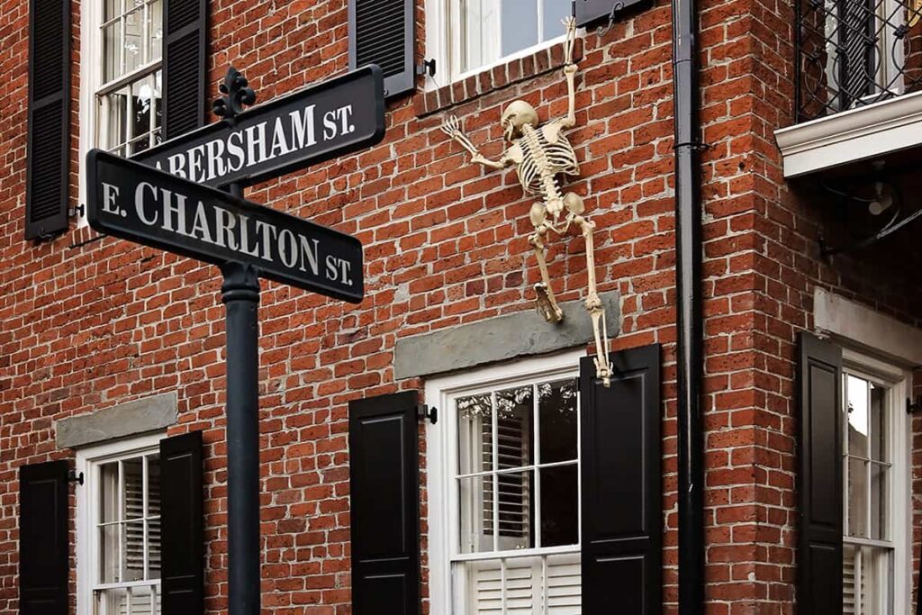 A skeleton is caught trying to scale the wall of a stately brick home at the corner of Habersham and E Charlton in Savannah's Historic District