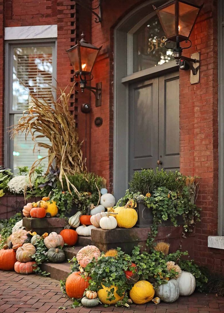 Front entrance to a stately brick home decorated with colorful pumpkins to accompany a list of restaurants open for Thanksgiving in Savannah.