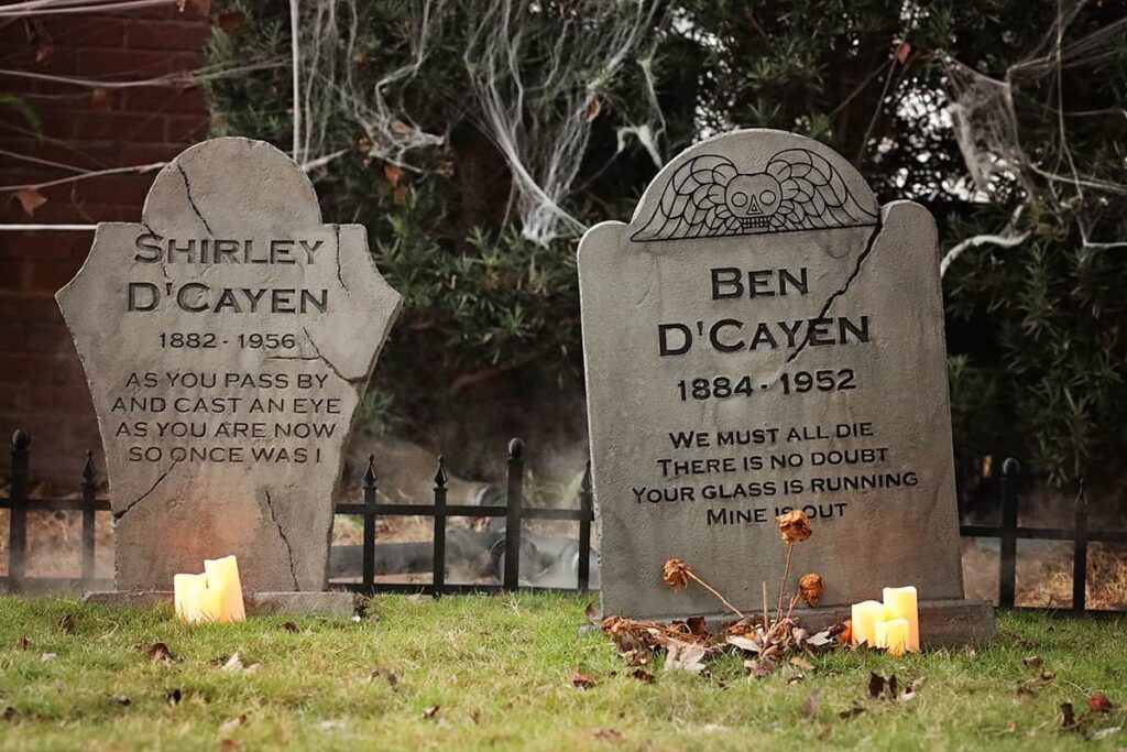 Gravestones for Shirley and Ben D'Cayen decorate a home in the yard of an Ardsley Park home