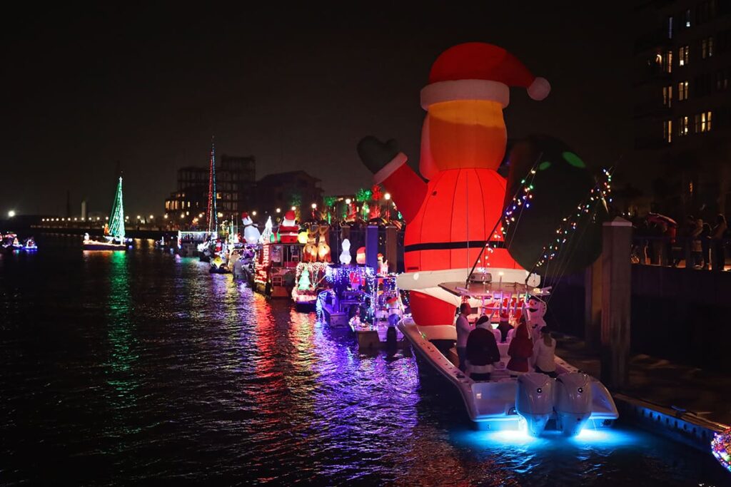 Dozens of colorfully decorated boats lined up for a the holiday boat parade to celebrate the start of Christmas in Savannah
