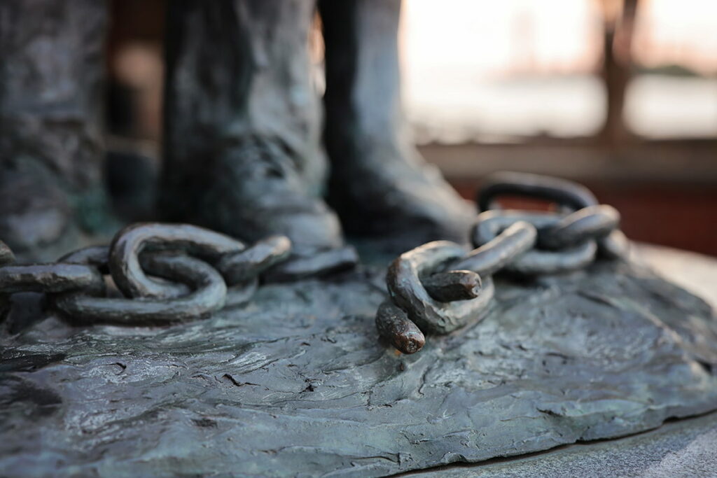 Broken chains encircle the feet of a Black family at the base of the African American Monument in Savannah